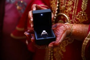 person holding a diamond ring